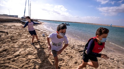 They play beach tag and other games while waiting for their turn on the Pico sail boat.