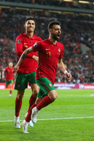 Bruno Fernandes celebrates with Cristiano Ronaldo after scoring. EPA