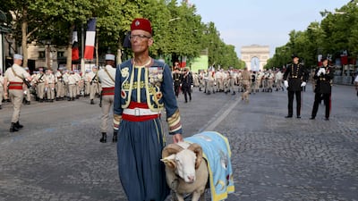 A soldier of the French Army's 1st Tirailleur Regiment and the unit's mascot, a ram named Messaoud, wait for the start of the annual Bastille Day military parade on the Champs Elysees Avenue in Paris. AFP