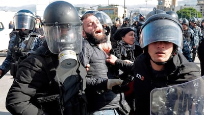 Lebanese security forces detain an anti-government protester during clashes in a demonstration in the centre of the capital Beirut. AFP