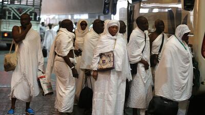 Muslim pilgrims line up to board a bus in the holy city of Makkah, bound for the tent-city of Mina, during the first day of the annual Hajj pilgrimage. AFP