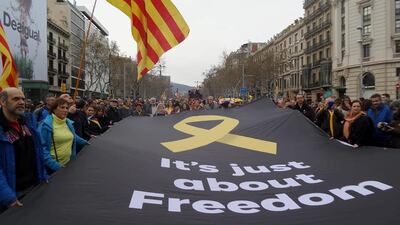 People hold a banner as they protest after former president Carles Puigdemont was detained in Germany, during a demonstration held by pro-independence associations in Barcelona, Spain, on March 25, 2018. Rafael Alvarez/Social Media via Reuters