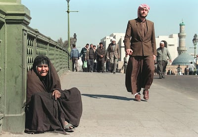 An elderly Iraqi woman begs in Baghdad, February 22, 1997, seven years into the UN sanctions. AFP