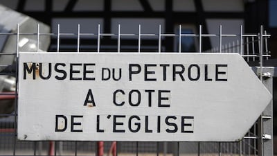 A sign on a fence, which reads Oil Museum next to the church", shows the direction for the French Oil Museum in Merkwiller-Pechelbronn. Vincent Kessler / Reuters