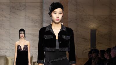 A column dress teamed with a cropped jacket and sheer trousers at Armani