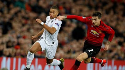 Paris Saint-Germain's Kylian Mbappe in action with Manchester United's Victor Lindelof. Reuters
