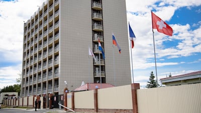 The Swiss flag is pictured in front of the Lada Resort Hotel, Switzerland's team base camp, in Togliatti, Russia. EPA