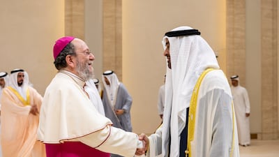 President Sheikh Mohamed greets Bishop Paolo Martinelli, head of the Roman Catholic Apostolic Vicariate of Southern Arabia, during the reception at Mushrif Palace.