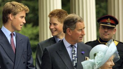 Princes William and Harry appear with the Queen Mother during celebrations to mark her 101st birthday in 2001. Getty Images