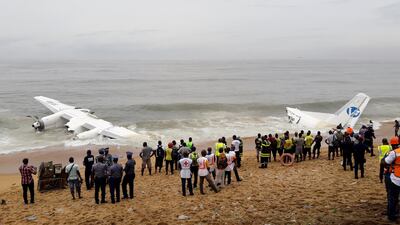 Policemen and rescuers stand near the wreckage of a cargo plane after it crashed in the sea near the international airport in Ivory Coast's main city, Abidjan. Luc Gnago / Reuters