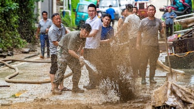 Residents clean up mud after flooding in Congjiang county, in the Chinese province of Guizhou. Reuters