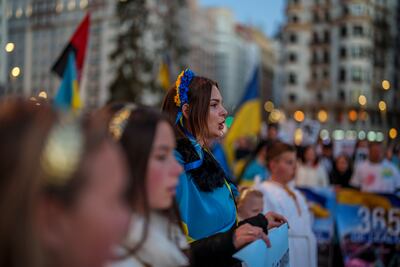 Ukrainian people take part in a protest marking one year since Russia's invasion of Ukraine in Madrid. AP