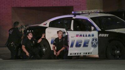 Dallas police respond after shots were fired during a protest over recent fatal shootings by police in Louisiana and Minnesota, in Dallas. Maria R Olivas / The Dallas Morning News via AP