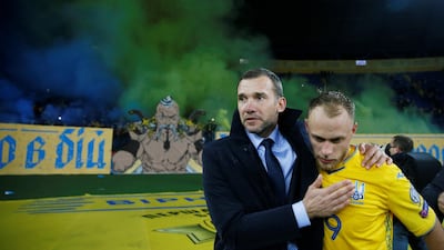 Ukraine's Mykola Matvyenko and coach Andriy Shevchenko celebrate at the end of the match. Reuters
