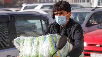 An Afghan man wears a face mask as he rides his motorbike in Herat province. Reuters