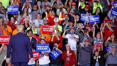 Former US president and Republican presidential candidate Donald Trump is greeted by supporters at a campaign rally in Grand Rapids, Michigan. AFP