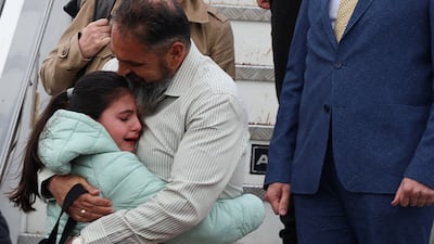 Lubomir Chanev, captain of the ship Galaxy Leader, hugs his daughter at Sofia Airport, Bulgaria, after being released by the Houthi rebels in Yemen following more than a year in captivity. Reuters