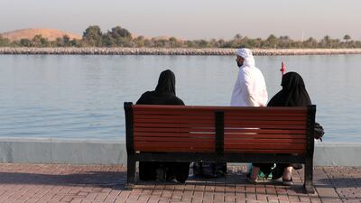 Residents in the early, cool morning along the Corniche in Abu Dhabi. Khushnum Bhandari / The National