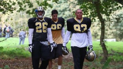 Deuce McAllister, Buck Ortega and Billy Miller of New Orleans leave a training session.