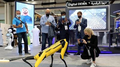 Visitors looking at the four-legged Spot Robot at a stand at Gitex in Dubai. Pawan Singh / The National