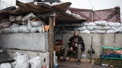 A member of Ukraine's Territorial Defence Forces at a checkpoint in Kyiv. Reuters