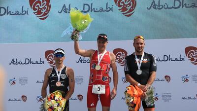 Tyler Butterfield, centre, surprised himself by winning the elite male long course division. Bas Diederen, right, and Sylvain Sudrie, left, and were second and third, respectively, in the Abu Dhabi International Triathlon on March 15, 2014. Ravindranath K / The National