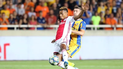 Ajax attacker David Neres, left, shields the ball from APOEL's Dragan Mihajlovic. EPA