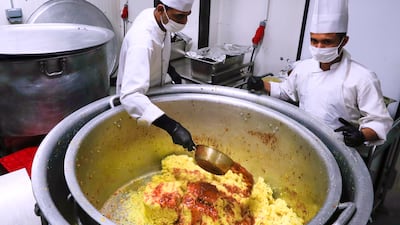 The biryani spices, rice and chicken are mixed to prepare biryani.