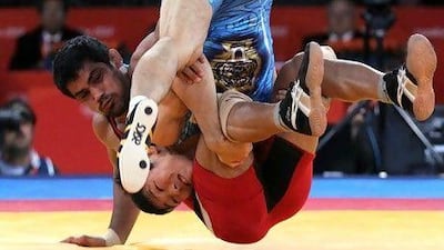 Tatsuhiro Yonemitsu of Japan (blue) fights with Sushil Kumar of India.