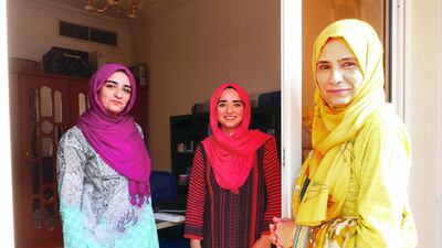 Najma Kolsawala, right, used to check on her daughters Neha Mohammed Tahir, centre, and Jawahir Mohammed Tahir from their home's shared balcony when the girls contracted Covid-19. Pawan Singh / The National