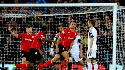 It's despair for Swansea City as Steven Caulker of Cardiff City, second from right, celebrates scoring the only goal of their Premier League match. Laurence Griffiths / Getty Images