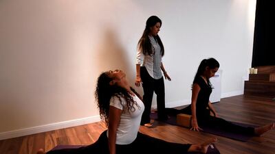 Nouf Marwaai, 38, the head of the Arab Yoga Foundation (C), instructs her yoga students with at her studio in the western Saudi Arabian city of Jeddah on September 7, 2018. Photo / AFP