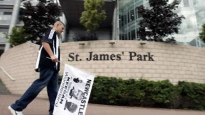 A Newcastle United fan protests outside of St James' Park.