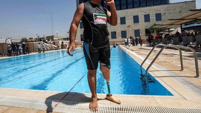 An Iraqi civilian who lost a limb during the government offensive against Isis in the northern city of Mosul stands by a swimming pool in Arbil, the capital of the Kurdish autonomous region in northern Iraq. AFP