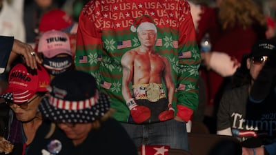 An attendee wears a holiday sweater featuring U.S. President Donald Trump during a rally with in Valdosta, Georgia, U.S. Bloomberg