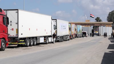Trucks of a humanitarian aid convoy have been waiting outside the border gate between Egypt and Gaza for days. EPA