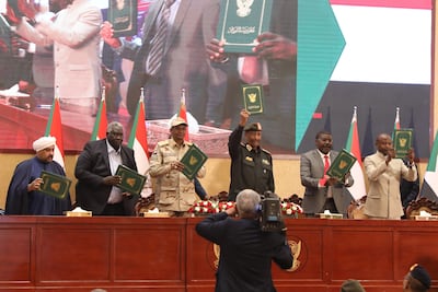 Sudanese military and civilian leaders, pictured in December last year, hold up copies of a framework agreement aimed at ending the country's political stalemate. EPA