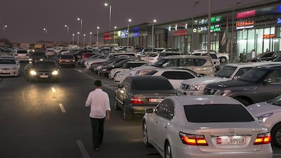 Al Shamkha, UNITED ARAB EMIRATES, Aug. 5, 2014: Salesmen and owners walk around, waiting for customers, on Tuesday evening, Aug. 5, 2014, while they work in their shops at the Motorworld car dealerships on the outskirts of Al Shamkha, near the Abu Dhabi Airport. Salespeople and owners unanimously expressed their frustration over slow sales, citing the compound's long distance from Abu Dhabi and the lack of surrounding facilities.(Silvia Razgova / The National)