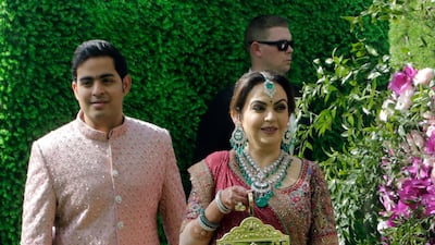Nita Ambani, wife of Reliance Industries Chairman Mukesh Ambani, arrives with her son Akash Ambani for his wedding. Photo: AP