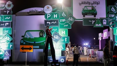 A man on stilts stands at the entrance of a driving awareness campaign center in Jeddah, Saudi Arabia June 21, 2018. Picture taken June 21, 2018. REUTERS/Zohra Bensemra