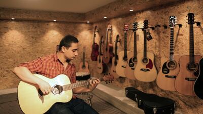 Raji Al Jaru in his shop in Gaza, the city’s first music store AFP