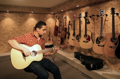 Raji Al Jaru in his shop in Gaza, the city’s first music store AFP