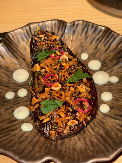 The smoked carmelised aubergine was garnished with crispy onion and hazelnuts. Hala Nasar / The National