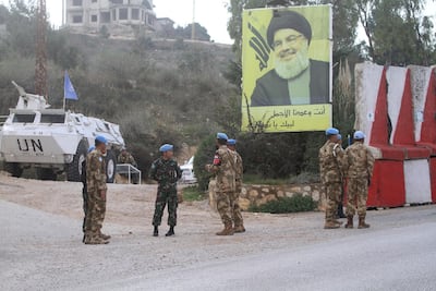 Indonesian UN peacekeepers stand in front a poster of Hezbollah leader Hassan Nasrallah, as they patrol the Lebanese side of the Lebanese-Israeli border in the southern village of Kfar Kila. AP