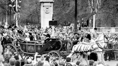King Faisal of Saudi Arabia waves in response to the crowd lining the Mall as he drives with the Queen to Buckingham Palace on arrival for his eight-day state visit, May 9, 1967. PA Archive/PA Images