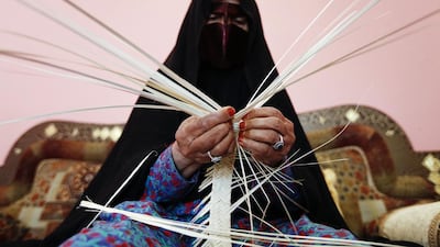 Shamsa Almazrouei, 80, weaves a traditional Emirati basket at her home, the kind of 'traditional' heritage that some commentators seem to think should be the only kind of heritage in the Emirates. Sarah Dea / The National