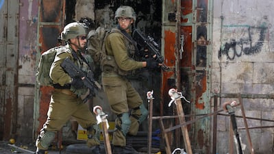 Israeli soldiers at the scene of a scuffle between Palestinians and Israeli settlers in Hebron in the Israeli-occupied West Bank. Reuters