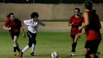 Reem Team, in white, takes on the Thursday Team, during the Women's Sevens League at The Jebel Ali Centre for Excellence football pitch. Jeffrey E Biteng / The National