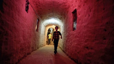 Syrian children play in the underground playground built to protect them from shelling. More than 280,000 people have been killed and millions have been displaces since Syria’s conflict broke out in March 2011.