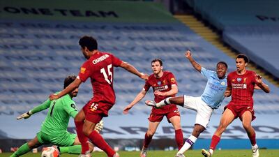 Manchester City's Raheem Sterling shoots and Liverpool's Alex Oxlade-Chamberlain deflects the ball into his own goal for Manchester City’s fourth goal. PA